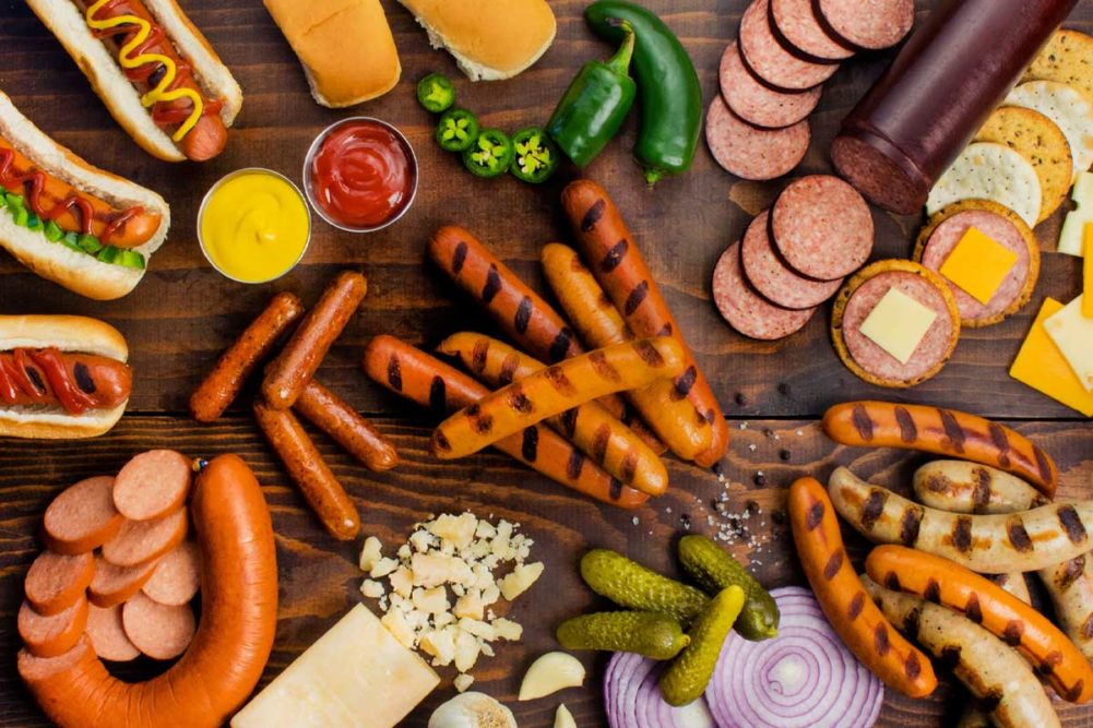 An assortment of sausages, hot dogs and condiments