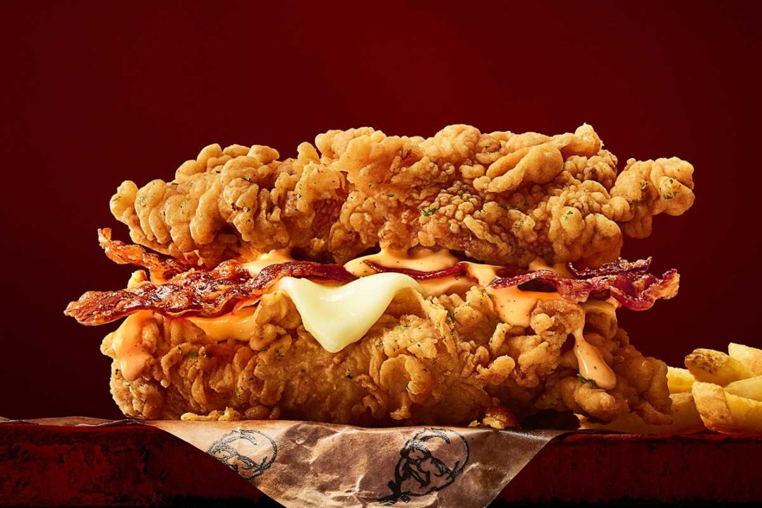 Double Down chicken sandwich with bacon, cheese and sauce, served between two breaded fried chicken fillets