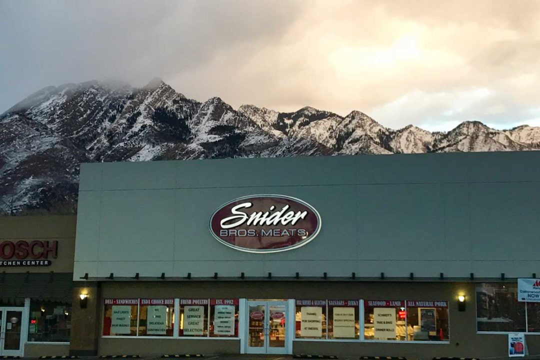 Exterior photo of Snider Bros. Meats with mountains in the background
