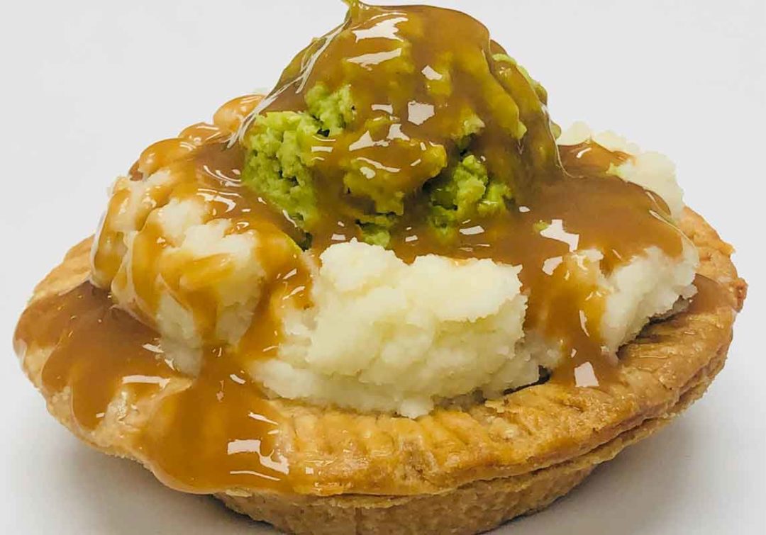 G'Day Gourmet meat pie topped with mashed potatoes and gravy