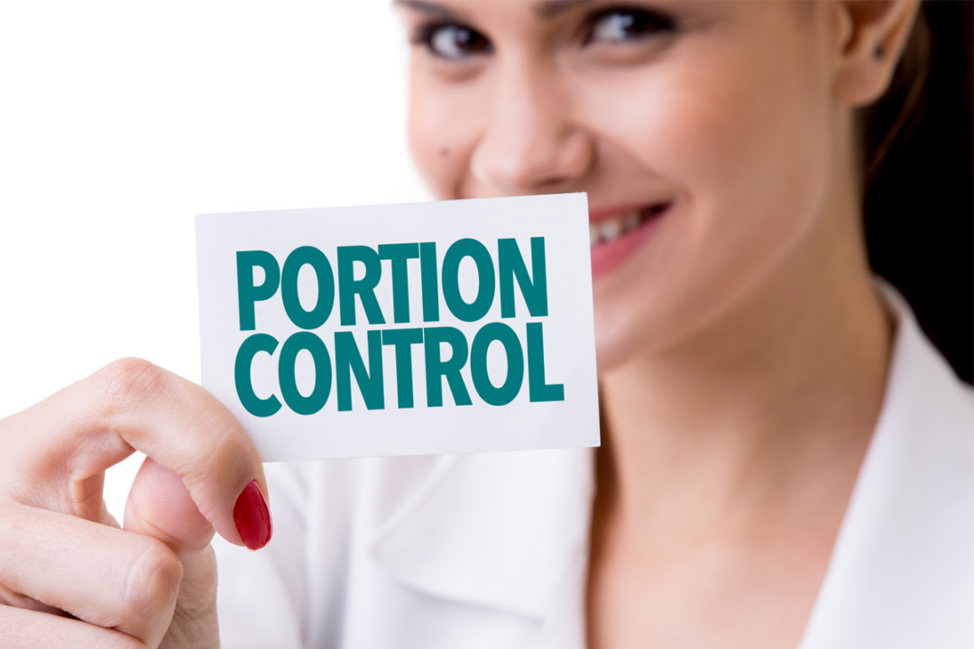 Woman holding portion control sign