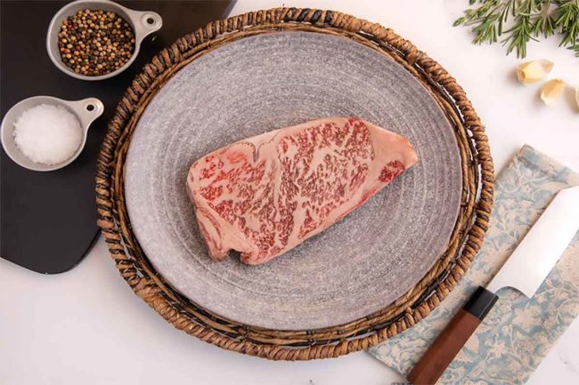 Photo of Hitachi-Gyu A5 Wagyu steak on a cutting board