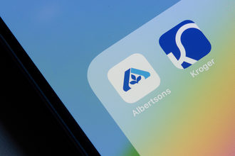 Albertsons and Kroger mobile app icons on an iPhone