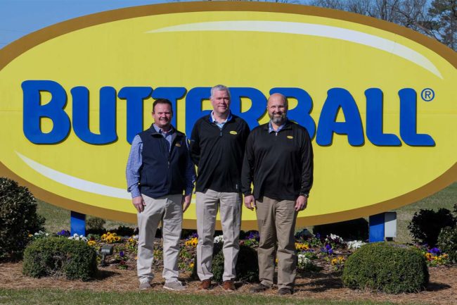 Butterball ops reps in front of sign